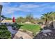 Backyard view of the putting green, desert landscaping, and blue sky at 13827 N Mesquite Ln, Fountain Hills, AZ 85268