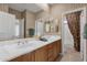 Bright bathroom with double sinks, wood cabinets, large mirror, and neutral decor at 13827 N Mesquite Ln, Fountain Hills, AZ 85268