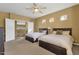 Bright bedroom with dual beds, ceiling fan, and convenient access to an ensuite bathroom at 13827 N Mesquite Ln, Fountain Hills, AZ 85268