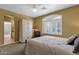 Comfortable bedroom featuring a cozy bed, ceiling fan, plantation shutters and neutral color scheme at 13827 N Mesquite Ln, Fountain Hills, AZ 85268