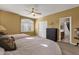 Tranquil bedroom with large window, ceiling fan, and ensuite bath for convenience and comfort at 13827 N Mesquite Ln, Fountain Hills, AZ 85268