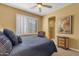 Comfortable bedroom with plantation shutters, ceiling fan, ensuite access and soothing decor at 13827 N Mesquite Ln, Fountain Hills, AZ 85268