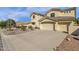 Stunning two-story home boasts a three-car garage and desert landscaping, showcasing curb appeal at 13827 N Mesquite Ln, Fountain Hills, AZ 85268