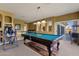A game room boasts a pool table, wet bar, and balcony access for ultimate entertainment at 13827 N Mesquite Ln, Fountain Hills, AZ 85268