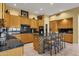 Spacious kitchen featuring wood cabinetry, granite countertops, a large island, and stainless steel appliances at 13827 N Mesquite Ln, Fountain Hills, AZ 85268