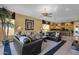 Spacious living room showing smooth flow to dining and kitchen featuring designer window accents and neutral color palette at 13827 N Mesquite Ln, Fountain Hills, AZ 85268