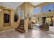 Spacious living room boasting high ceilings, large windows, staircase, and stylish decor, perfect for entertaining at 13827 N Mesquite Ln, Fountain Hills, AZ 85268
