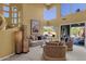 Bright living room with high ceilings, multiple windows, comfortable seating, and stylish floor lamps at 13827 N Mesquite Ln, Fountain Hills, AZ 85268