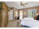 Spacious main bedroom with plush carpet, desk, ceiling fan, and plantation shutters for natural light at 13827 N Mesquite Ln, Fountain Hills, AZ 85268