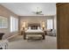 Serene primary bedroom featuring neutral tones, plantation shutters, and a comfortable seating area at 13827 N Mesquite Ln, Fountain Hills, AZ 85268