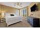 Spacious bedroom features large bed, windows, ceiling fan, and TV at 13827 N Mesquite Ln, Fountain Hills, AZ 85268