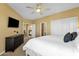 Bedroom with a ceiling fan, and an entertainment unit next to a window at 13827 N Mesquite Ln, Fountain Hills, AZ 85268