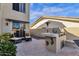 Outdoor patio showcasing a built-in grill, seating area, and manicured landscaping for relaxing and entertaining at 13827 N Mesquite Ln, Fountain Hills, AZ 85268