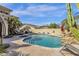Beautiful pool with waterfall, spa, and seating area, perfect for outdoor relaxation at 13827 N Mesquite Ln, Fountain Hills, AZ 85268