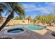 Sparkling pool with waterfall feature, jacuzzi, and lush desert landscaping at 13827 N Mesquite Ln, Fountain Hills, AZ 85268
