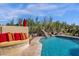 Inviting pool with a waterfall feature and a cozy seating area for relaxation at 13827 N Mesquite Ln, Fountain Hills, AZ 85268