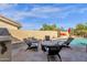Outdoor poolside featuring a built-in grill and comfortable seating area, perfect for relaxing and entertaining at 13827 N Mesquite Ln, Fountain Hills, AZ 85268