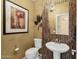 Stylish powder room featuring decorative tile accents, pedestal sink, and elegant lighting fixtures at 13827 N Mesquite Ln, Fountain Hills, AZ 85268