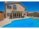 A luxurious pool and backyard features a covered patio, green trees, and plants perfect for outdoor living at 1431 W Mountain Sky Ave, Phoenix, AZ 85045