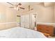Bright bedroom featuring a ceiling fan, neutral walls and carpet, and convenient access to closets at 1431 W Mountain Sky Ave, Phoenix, AZ 85045