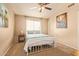Well-lit bedroom with a ceiling fan, carpet, and modern accents that create a cozy and relaxing atmosphere at 1431 W Mountain Sky Ave, Phoenix, AZ 85045