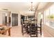 Open dining room adjacent to kitchen with black dining set and view into kitchen at 1431 W Mountain Sky Ave, Phoenix, AZ 85045