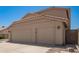Spacious three-car garage with neutral doors, providing ample parking and storage space at 1431 W Mountain Sky Ave, Phoenix, AZ 85045