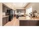 Well-lit kitchen features dark cabinets, granite countertops, and stainless steel appliances at 1431 W Mountain Sky Ave, Phoenix, AZ 85045