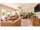 Cozy living room with a fireplace, ceiling fan, and leather furniture at 1431 W Mountain Sky Ave, Phoenix, AZ 85045