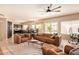 Open-concept living room with modern leather sofas, white rug, and ample natural light at 1431 W Mountain Sky Ave, Phoenix, AZ 85045