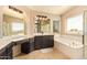 Bright main bathroom features large soaking tub, separate shower, and dual sink vanity at 1431 W Mountain Sky Ave, Phoenix, AZ 85045