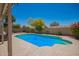 Beautiful backyard pool with a blue bottom and a beige stone pool deck at 1431 W Mountain Sky Ave, Phoenix, AZ 85045