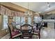 Open concept dining area showcasing a round table and chairs, decorative chandelier, and kitchen view at 14334 W Shawnee Trl, Surprise, AZ 85374