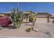 Desert landscaping and a paved driveway complement the exterior of this house at 14334 W Shawnee Trl, Surprise, AZ 85374