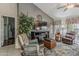 Cozy living room showcasing a fireplace, comfortable seating, and a view to the outside patio at 14334 W Shawnee Trl, Surprise, AZ 85374