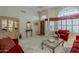 Bright living room with high ceilings, large windows, tile flooring, and comfortable seating at 14334 W Shawnee Trl, Surprise, AZ 85374