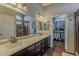 Main bathroom with double sinks, and walk in shower, with a walk in closet at 14334 W Shawnee Trl, Surprise, AZ 85374