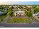 Expansive property with circular driveway and mature trees, offering a serene setting and ample space at 1438 E Mesquite St, Gilbert, AZ 85296