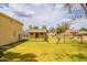 Expansive backyard with lush green grass, perimeter fencing and several outbuildings at 1438 E Mesquite St, Gilbert, AZ 85296