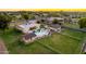Beautiful backyard aerial view with pool, covered patio, accessory buildings, all surrounded by a large, well-maintained lawn at 1438 E Mesquite St, Gilbert, AZ 85296