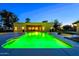 Stunning backyard featuring a radiant green pool, spacious patio, and a cozy outdoor dining area at 1438 E Mesquite St, Gilbert, AZ 85296