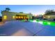 Large backyard showcasing a sparkling green pool, expansive patio, and a welcoming outdoor lounge space at 1438 E Mesquite St, Gilbert, AZ 85296