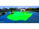 A luminous green pool is the focal point of this serene backyard oasis, perfect for evening relaxation at 1438 E Mesquite St, Gilbert, AZ 85296