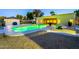 Expansive backyard with a captivating green pool, complemented by a patio and desert-friendly landscaping at 1438 E Mesquite St, Gilbert, AZ 85296