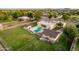 Large backyard aerial view with a pool, patio, and accessory buildings, all enclosed by fencing for privacy at 1438 E Mesquite St, Gilbert, AZ 85296