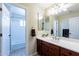 Bathroom with vanity, sink, mirror, and open doorway to the tub/shower combination at 1438 E Mesquite St, Gilbert, AZ 85296