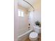 Cozy bathroom features a shower and tub with white tile, a toilet, and natural light at 1438 E Mesquite St, Gilbert, AZ 85296