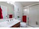 Bright bathroom featuring vanity, sink, mirror, toilet, and glass enclosed shower at 1438 E Mesquite St, Gilbert, AZ 85296
