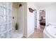 Bathroom with a glass block shower, soaking tub, and view into the bedroom at 1438 E Mesquite St, Gilbert, AZ 85296