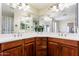 Bathroom featuring double sinks with wood cabinets and a large mirror reflecting the spacious area at 1438 E Mesquite St, Gilbert, AZ 85296